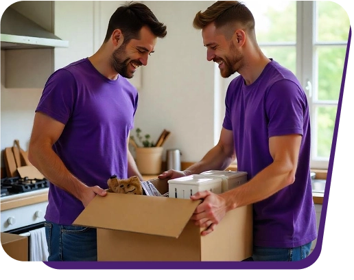 Two movers packing boxes